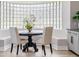 Bright breakfast nook featuring a round table, seating, and a unique glass block window at 303 Waterwood Dr, Yalaha, FL 34797