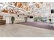 Spacious event space with hardwood floors, chandeliers, and seating areas for gatherings at 303 Waterwood Dr, Yalaha, FL 34797