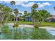 The backyard with a beach makes this property a stunning luxury residence at 303 Waterwood Dr, Yalaha, FL 34797