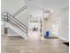 Foyer with modern staircase, double door entry and modern flooring at 303 Waterwood Dr, Yalaha, FL 34797