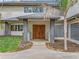 Elegant front entrance featuring a double door entry, glass block window and modern grey pillars at 303 Waterwood Dr, Yalaha, FL 34797