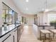 Modern kitchen featuring stainless steel appliances, a center island, and large windows with outdoor views at 303 Waterwood Dr, Yalaha, FL 34797