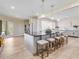 Open kitchen design with an expansive island, bar stool seating, and recessed lighting at 303 Waterwood Dr, Yalaha, FL 34797