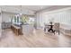 Open floor plan with a kitchen island, bar seating, and a cozy breakfast nook with large windows at 303 Waterwood Dr, Yalaha, FL 34797