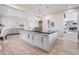 Bright kitchen with a large island, sleek countertops, stylish cabinetry, and modern appliances at 303 Waterwood Dr, Yalaha, FL 34797