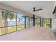 Outdoor lanai overlooking water with ceiling fans, and screened enclosure for comfort and views at 303 Waterwood Dr, Yalaha, FL 34797