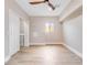 Bright and spacious laundry room featuring wood-look floors, window, and washer and dryer hookups at 303 Waterwood Dr, Yalaha, FL 34797