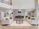 Open concept living room with high ceilings, a sleek fireplace, and stylish decor, perfect for entertaining guests at 303 Waterwood Dr, Yalaha, FL 34797