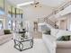 Bright living room featuring soaring ceilings, a modern staircase, and a wall of windows offering views of the outside at 303 Waterwood Dr, Yalaha, FL 34797