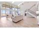 Open-concept living room with high ceilings, large windows, and stunning lake views at 303 Waterwood Dr, Yalaha, FL 34797