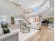 Spacious living room with high ceilings, modern staircase, a piano and lots of natural light at 303 Waterwood Dr, Yalaha, FL 34797