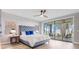 Spacious main bedroom with a king bed, ceiling fan, and access to an outdoor seating area at 303 Waterwood Dr, Yalaha, FL 34797