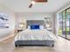 Bright main bedroom with a king bed, ceiling fan, and access to an outdoor seating area at 303 Waterwood Dr, Yalaha, FL 34797