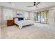 Expansive main bedroom features waterfront views, plush carpeting, ceiling fan, and two windows at 303 Waterwood Dr, Yalaha, FL 34797