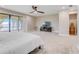 Spacious main bedroom features water views, plush carpeting, a ceiling fan, and television console at 303 Waterwood Dr, Yalaha, FL 34797