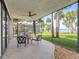 This screened patio offers a great view of the water with its comfortable seating area with an overhead fan at 303 Waterwood Dr, Yalaha, FL 34797