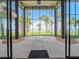 The covered patio features a beautiful view of the ocean and beach through the large glass windows at 303 Waterwood Dr, Yalaha, FL 34797