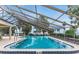 Inviting screened-in community pool with ample seating and serene water views at 303 Waterwood Dr, Yalaha, FL 34797