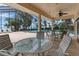 Leisurely screened pool area with tables, chairs, and tranquil outdoor space at 303 Waterwood Dr, Yalaha, FL 34797