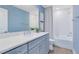 Bathroom featuring blue walls, a white countertop vanity and a bathtub/shower at 3110 Norcott Dr, Davenport, FL 33837
