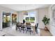 Light-filled dining area featuring a wood table with black chairs and a sliding door to the lanai at 3110 Norcott Dr, Davenport, FL 33837