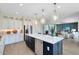 Gourmet kitchen with stainless appliances, island with seating, open concept dining and living area at 3110 Norcott Dr, Davenport, FL 33837