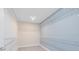 This walk-in closet has carpeted floors, light gray walls and metal shelves along the perimeter at 3110 Norcott Dr, Davenport, FL 33837