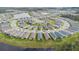 Aerial view of a well-maintained community featuring a circular street design and a scenic pond at 3412 Yellowtop Loop, Clermont, FL 34714