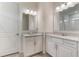 Bright bathroom featuring dual vanities with white cabinets, granite countertops, and a separate water closet at 3412 Yellowtop Loop, Clermont, FL 34714