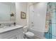 Clean and modern bathroom with a white vanity, granite countertop, and a shower-tub combination with decorative curtain at 3412 Yellowtop Loop, Clermont, FL 34714