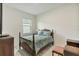 Cozy bedroom featuring a four-poster bed with a patterned comforter, offering a comfortable and inviting retreat at 3412 Yellowtop Loop, Clermont, FL 34714
