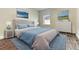 Comfortable bedroom with a plush headboard, soft blue accents, and ample natural light, creating a relaxing retreat at 3412 Yellowtop Loop, Clermont, FL 34714