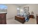 Comfortable bedroom featuring a wooden chest, nautical artwork, and a sunlit window with a view of the outdoors at 3412 Yellowtop Loop, Clermont, FL 34714