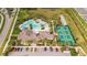 Overhead shot showing a resort-style community pool, tennis courts, parking, and landscaped grounds at 3412 Yellowtop Loop, Clermont, FL 34714