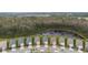 Aerial shot of a neighborhood nestled beside a serene pond and lush forest, offering a peaceful retreat at 3412 Yellowtop Loop, Clermont, FL 34714