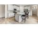 Modern kitchen with granite countertops, stainless steel appliances and an island with seating at 3412 Yellowtop Loop, Clermont, FL 34714