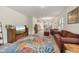 Spacious living room with a large leaf-patterned rug, creating a cozy and inviting atmosphere with bright natural light at 3412 Yellowtop Loop, Clermont, FL 34714