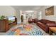 Open concept living room with a large rug, flowing into the kitchen and dining area, creating a cohesive and bright space at 3412 Yellowtop Loop, Clermont, FL 34714