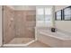 Bathroom featuring a large glass enclosed shower, soaking tub, and plantation shutters at 3630 Supreme Ct, Apopka, FL 32703