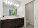 Bright bathroom featuring double vanity with dark brown cabinets at 3969 Southern Vista Loop, St Cloud, FL 34772