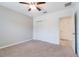 Well-lit bedroom featuring neutral walls, carpet, ceiling fan, and closet at 3969 Southern Vista Loop, St Cloud, FL 34772