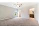 Bright bedroom with ceiling fan, carpet floors, and view of a walk-in closet at 3969 Southern Vista Loop, St Cloud, FL 34772