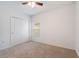 Neutral bedroom featuring carpet floors, a closet, a window, and ceiling fan at 3969 Southern Vista Loop, St Cloud, FL 34772