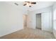 Neutral bedroom featuring carpet floors, a closet, a window, and ceiling fan at 3969 Southern Vista Loop, St Cloud, FL 34772
