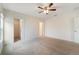 Bright bedroom with ceiling fan, carpet floors, and two doorways at 3969 Southern Vista Loop, St Cloud, FL 34772