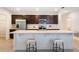 Well-equipped kitchen with a large island, stainless steel appliances, and dark wood cabinetry at 3969 Southern Vista Loop, St Cloud, FL 34772