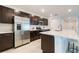 Contemporary kitchen featuring stainless appliances, quartz countertops, and ample cabinet storage at 3969 Southern Vista Loop, St Cloud, FL 34772