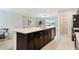 Open-concept kitchen with a large island, stainless steel appliances, and seamless flow to the living area at 3969 Southern Vista Loop, St Cloud, FL 34772