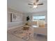 Bright living room with a decorative rug, modern furniture, and a sliding glass door with a lake view at 3969 Southern Vista Loop, St Cloud, FL 34772