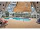 Covered pool area featuring a uniquely shaped pool, sun-drenched deck and surrounding greenery at 4522 Flagg St, Orlando, FL 32812